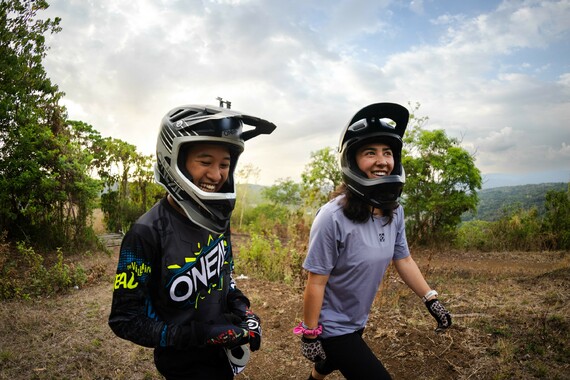 Two women wearing mountain bike equipment